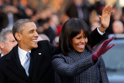 image: President Barack Obama and first lady Michelle Obama walk and wave after emerging from the presidential limousine during the inaugural parade from the Capitol to the White House in Washington, Jan. 21, 2013.